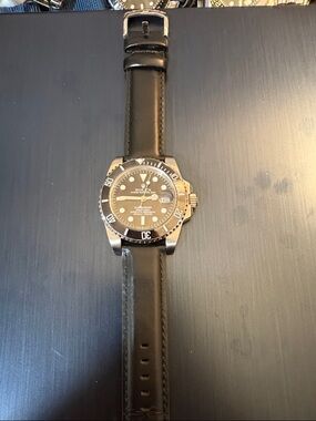 Rolex Black Dial Watch with Silver Accents and Black Leather Strap